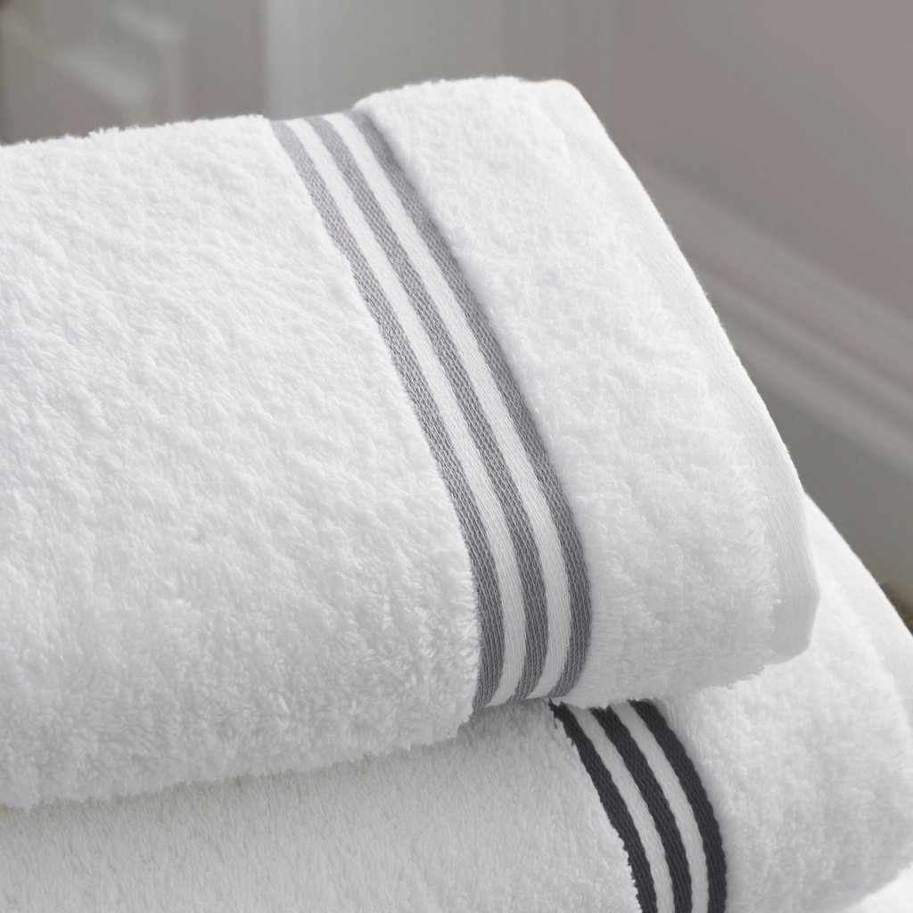 Two folded white bath towels stacked