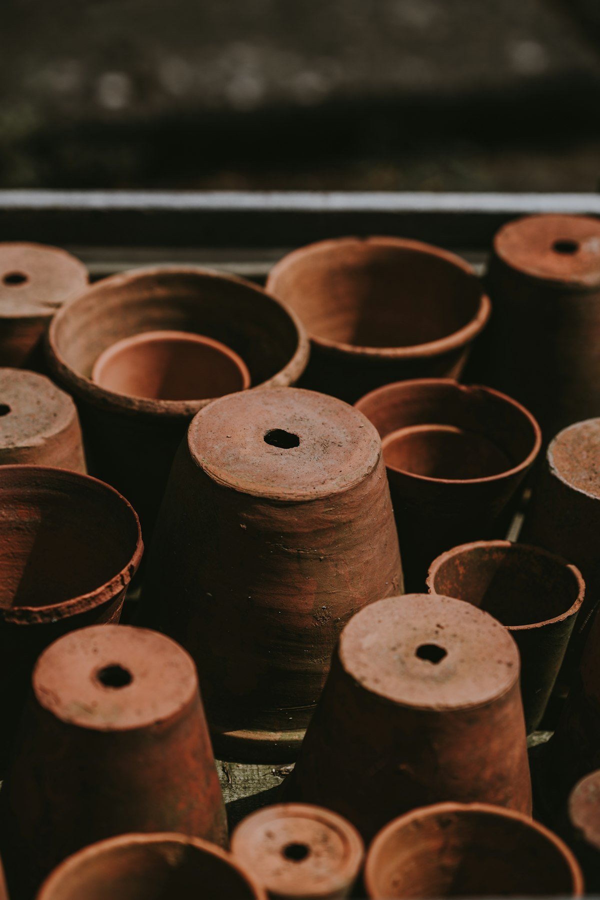 Three brown terracotta pots in different sizes