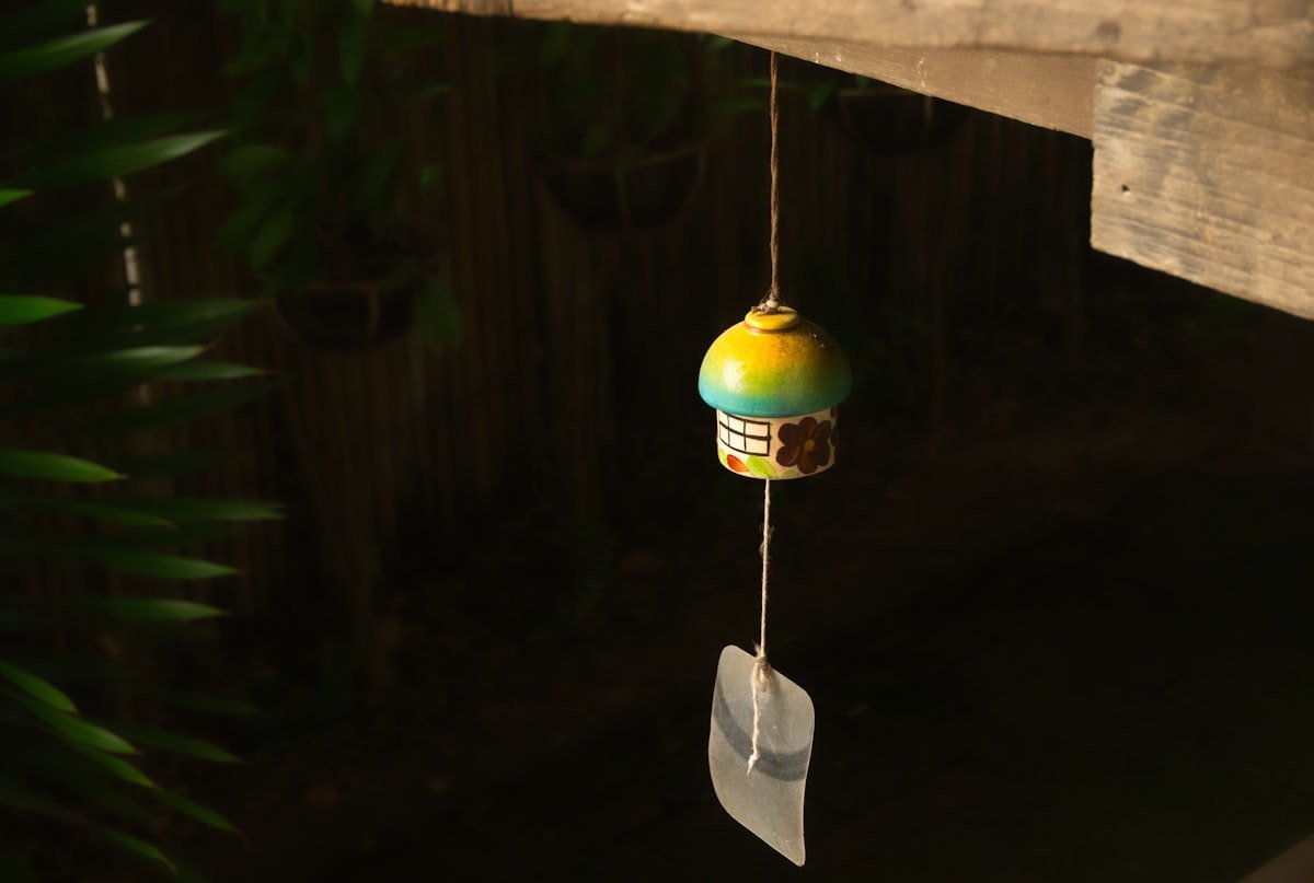 Wooden bird feeder hanging on a fence